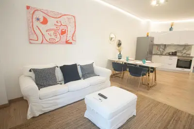 a living room with a white couch and a table at A.P Athens in Athens