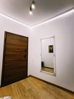 a room with a door and a mirror on the wall at A.P Athens in Athens
