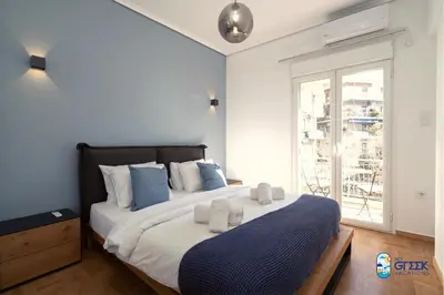 a bedroom with a large bed and a window at The Spiritual Athens Apartment in Athens