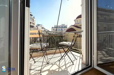 a pair of chairs sitting on a balcony at The Spiritual Athens Apartment in Athens