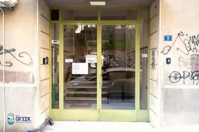 a door to a building with graffiti on it at The Spiritual Athens Apartment in Athens