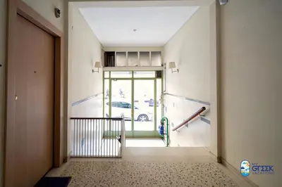 a hallway with a door with a car outside at The Spiritual Athens Apartment in Athens