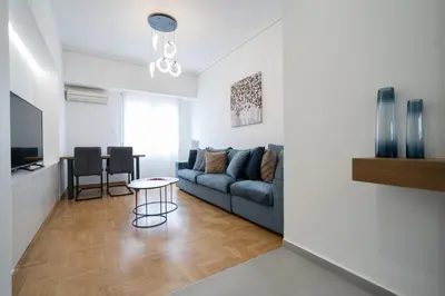 a living room with a couch and a table at The Spiritual Athens Apartment in Athens