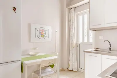 a kitchen with white cabinets and a sink at Modern full apt near acropolis/vaccinatedHosts in Athens