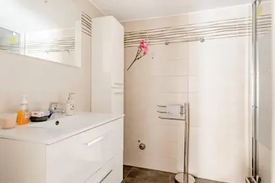 a white bathroom with a shower and a sink at Modern full apt near acropolis/vaccinatedHosts in Athens