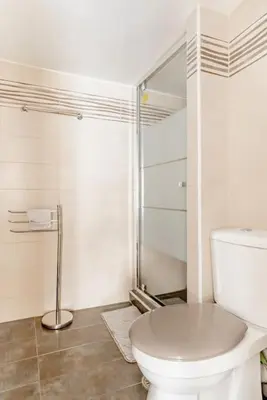 a white bathroom with a toilet and a shower at Modern full apt near acropolis/vaccinatedHosts in Athens