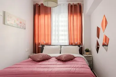 a bedroom with a large bed with red curtains at Brand New Bright modern 6bdr apt-1min to Acropolis in Athens