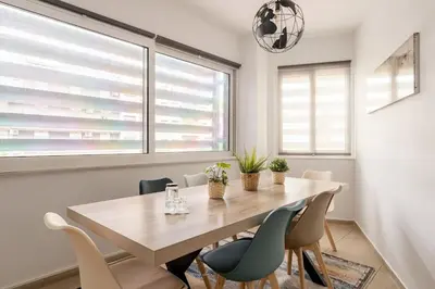 a dining room with a wooden table and chairs at Brand New Bright modern 6bdr apt-1min to Acropolis in Athens