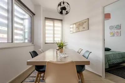 a dining room with a wooden table and chairs at Brand New Bright modern 6bdr apt-1min to Acropolis in Athens
