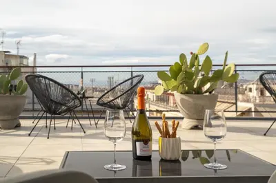 a bottle of wine sitting on a table with wine glasses at Strefi Hill Suites in Athens