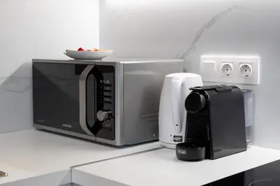 a microwave oven sitting on a counter with a plate on it at Strefi Hill Suites in Athens