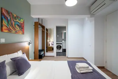 a bedroom with a bed with towels on it at Strefi Hill Suites in Athens