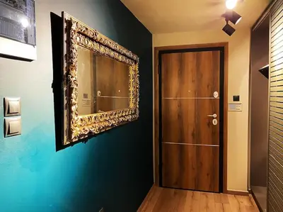 a mirror on a wall next to a door at Athens Skylight Condo in Athens