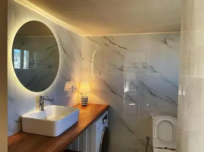 a bathroom with a sink and a mirror at Athens Skylight Condo in Athens