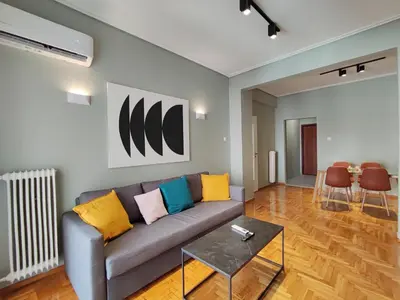 a living room with a couch and a table at Veno Apartments Goudi in Athens