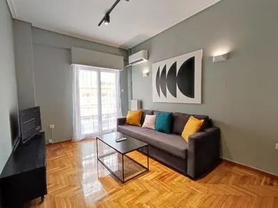 a living room with a couch and a table at Veno Apartments Goudi in Athens