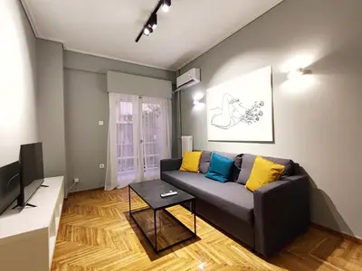 a living room with a couch and a tv at Veno Apartments Goudi in Athens