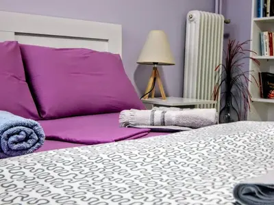 a bedroom with a bed and a purple pillow at 2 Bed Flat - Sleeps 4 - Pets - Parking - Wifi in Athens