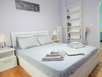 a bedroom with a white bed with towels on it at 2 Bed Flat - Sleeps 4 - Pets - Parking - Wifi in Athens
