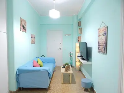 a blue living room with a couch and a tv at 2 Bed Flat - Sleeps 4 - Pets - Parking - Wifi in Athens
