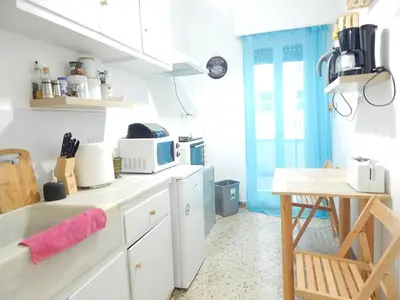 a kitchen with white cabinets and a wooden table at 2 Bed Flat - Sleeps 4 - Pets - Parking - Wifi in Athens