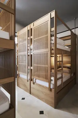 a room with wooden bunk beds in a room at When in Athens Hostel in Athens