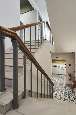 a staircase in a home with white walls at When in Athens Hostel in Athens