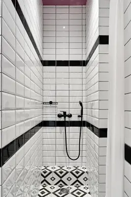 a bathroom with a shower with black and white tiles at When in Athens Hostel in Athens