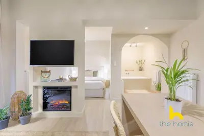 a living room with a tv and a fireplace at Romantic Luxury Hideaway Near Acropolis with Jacuzzi in Athens