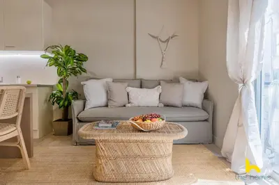 a living room with a couch and a table at Romantic Luxury Hideaway Near Acropolis with Jacuzzi in Athens