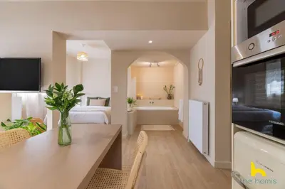 a living room with a dining table and a bathroom at Romantic Luxury Hideaway Near Acropolis with Jacuzzi in Athens
