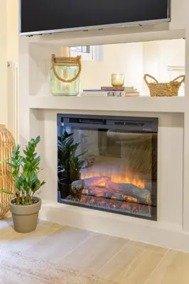 a living room with a fireplace with a fire at Romantic Luxury Hideaway Near Acropolis with Jacuzzi in Athens