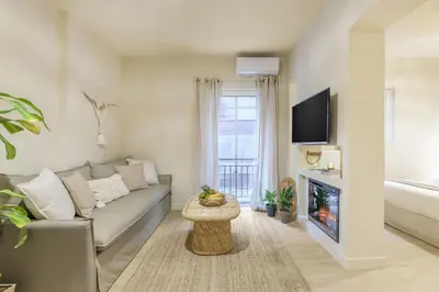 a living room with a couch and a fireplace at Romantic Luxury Hideaway Near Acropolis with Jacuzzi in Athens
