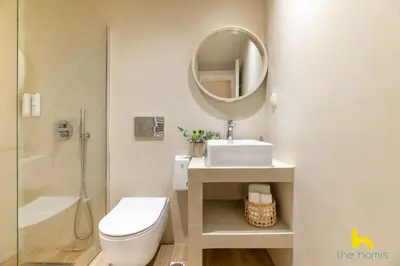 a bathroom with a toilet and a sink and a mirror at Romantic Luxury Hideaway Near Acropolis with Jacuzzi in Athens