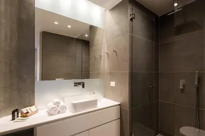 a bathroom with a sink and a shower at Urban APT with Stunning Acropolis View & Roofdeck in Athens