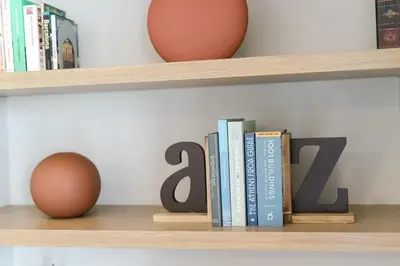 a wooden shelf with books and an egg on it at Urban APT with Stunning Acropolis View & Roofdeck in Athens