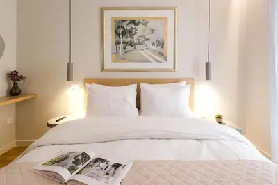 a bedroom with a bed with a book on it at Urban APT with Stunning Acropolis View & Roofdeck in Athens