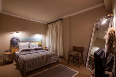 a bedroom with a bed and a painting on the wall at THE CACTI HOUSE in Athens
