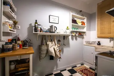 a kitchen with a counter and a shelf on the wall at THE CACTI HOUSE in Athens