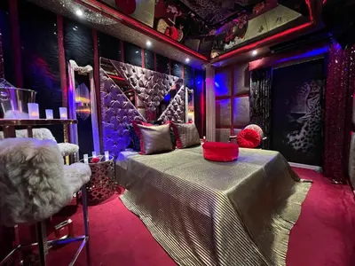 a room with a bed in a room with purple lights at Priamos Hotel Erato in Athens