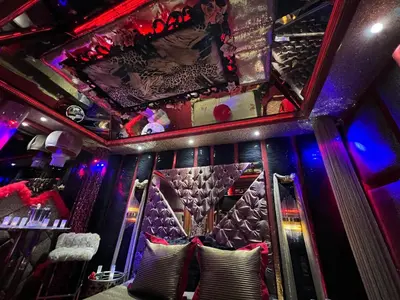 a bar with red and purple lighting and pillows at Priamos Hotel Erato in Athens