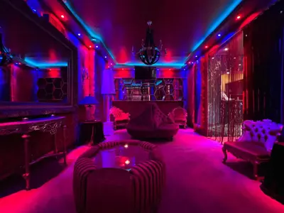 a room with purple and blue lights and chairs at Priamos Hotel Erato in Athens