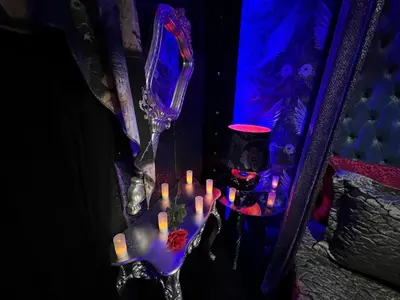a mirror with a bunch of candles on a table at Priamos Hotel Erato in Athens