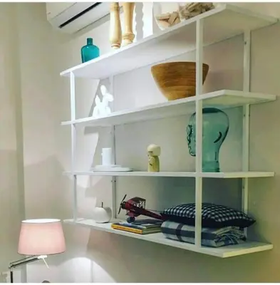 a white shelf with a vase and other items on it at Nikaia Metro House in Piraeus