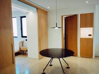 a dining room with a table and a hallway at Athens Tower in Athens