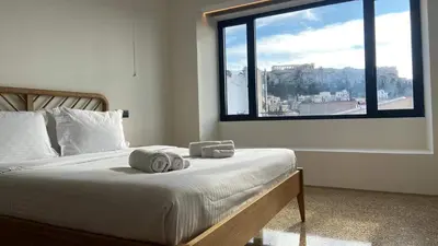 a bedroom with a bed and a large window at Athens Tower in Athens