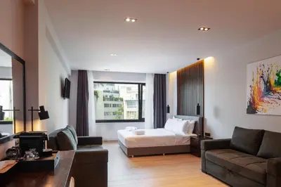 a hotel room with a bed and a couch at Athens Tower in Athens