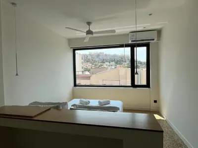 a bedroom with a bed and a large window at Athens Tower in Athens