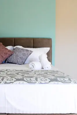 a bed with white sheets and pillows on it at The frescamento.collection apartment in Athens