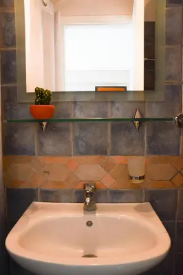 a white sink in a bathroom with a window at The frescamento.collection apartment in Athens